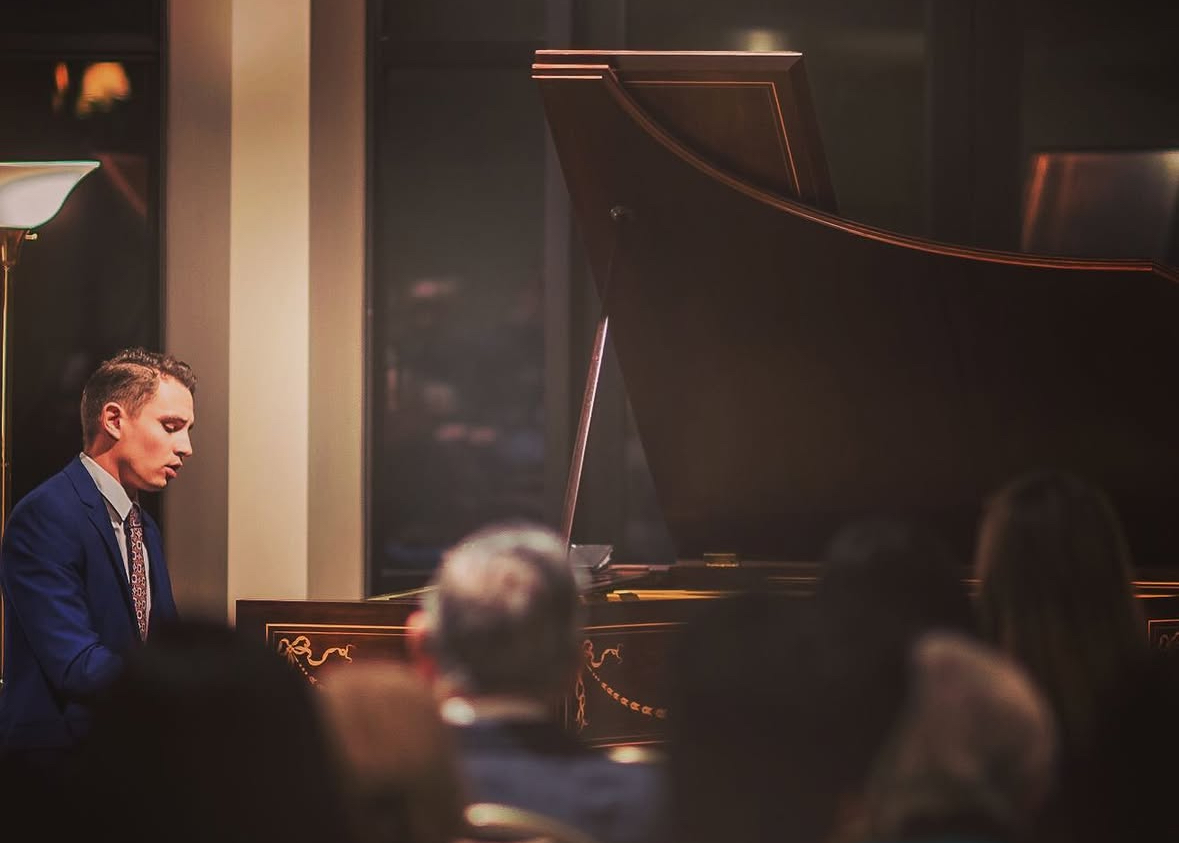 Michael Noble performing at a grand piano